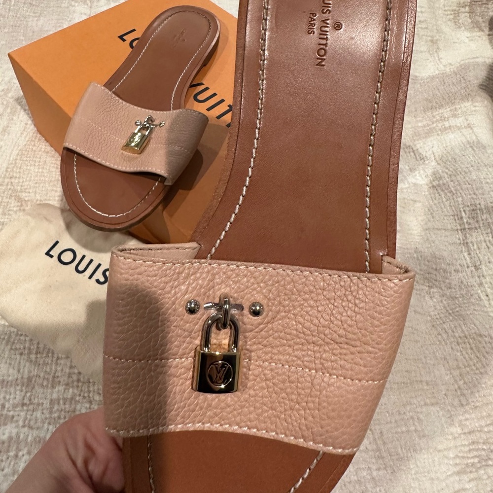 Louis Vuitton lock it flat mules. Worn but still in good condition.